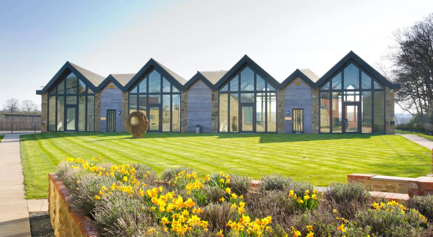 Prestwick Park Buildings with grass area and sculpture